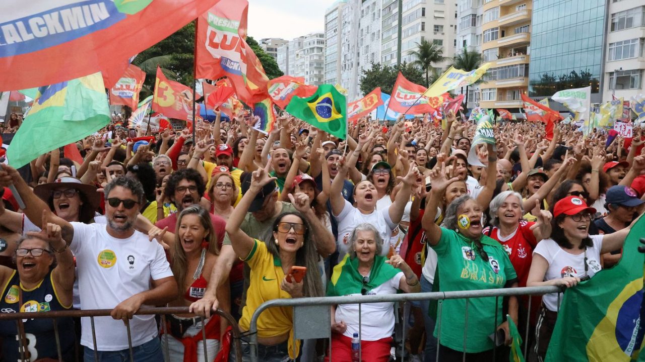 Eleitores brasileiros em frente a urna de votação