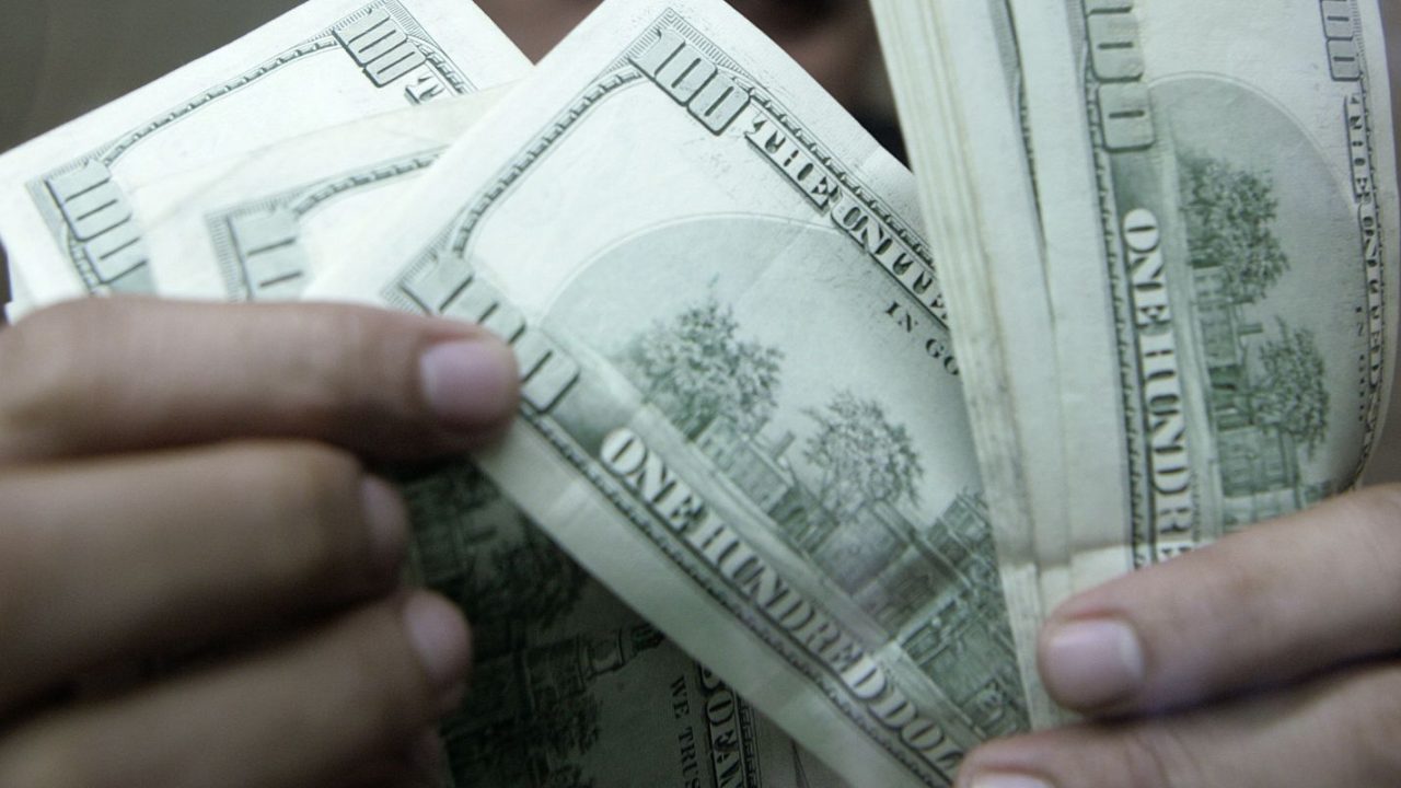 Tela de negociação mostrando o dólar cotado a R$ 4,98 e o Ibovespa em alta