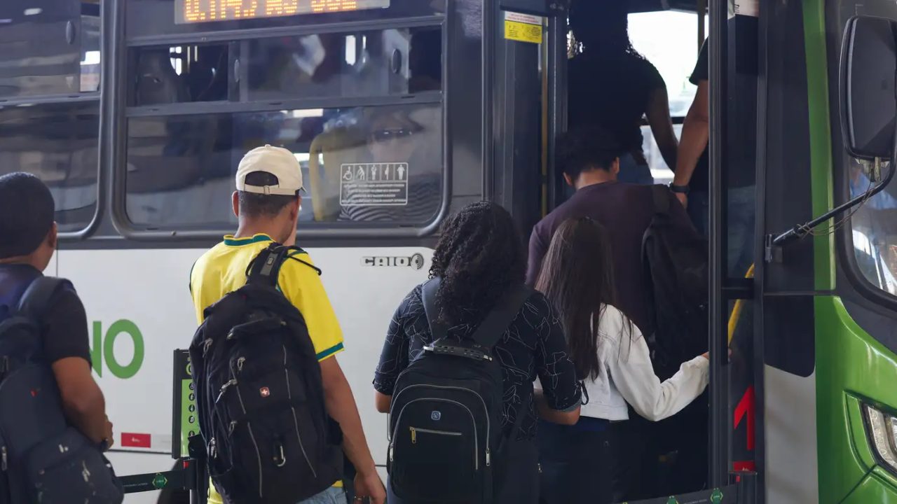 Eleitores embarcando em ônibus gratuito durante o segundo turno das eleições de 2026